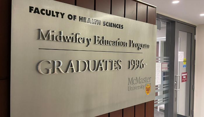 Sign outside the Midwifery Education Program's office. Reads Faculty of Health Science Midwifery Education Program Graduates 1996.
